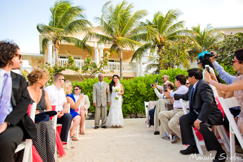 Bride walking down the beach isle Jamaica